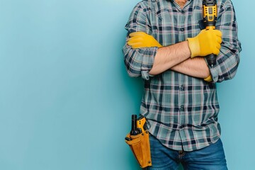 handyman holding electric screwdriver home repair and maintenance service concept closeup portrait on light blue background