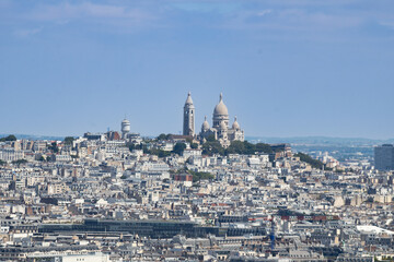 Sacré-Cœur is a basilica on top of Montmartre hill (Paris, France). Panoramic view of the roofs of the buildings around the Tour Eiffel, Paris, France