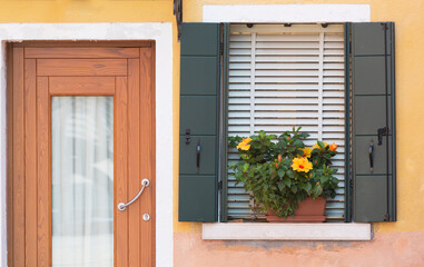 Window on a wall, decorated with blooming flowers