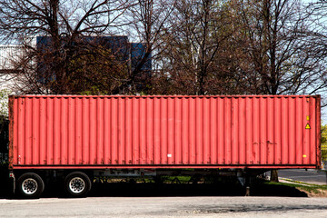 An unidentified shipping container on a transport trailer