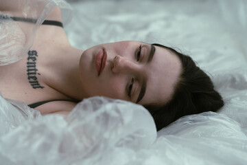 Contemplative Beauty: Woman under white sheet