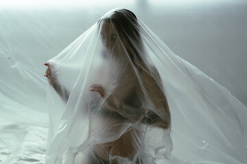 Surreal Portrait of a Woman Enveloped in a Sheer Veil