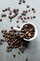 Close-up view of coffee beans placed inside a vintage porcelain cup, set on a rustic burlap background.