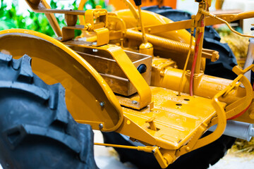 Detail of a small tractor with yellow construction tracks, Caterpillar Ten