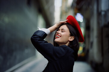 Fashion woman smile with teeth and fun tourist in stylish clothes in jacket and red beret walking...