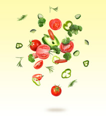 Different fresh vegetables in air on yellow gradient background