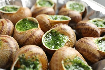 Delicious cooked snails on table, closeup view