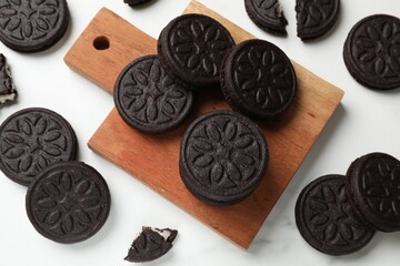 Tasty sandwich cookies on white table, flat lay