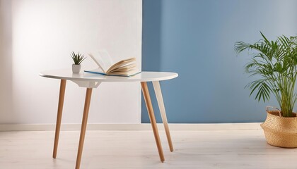 Modern minimalistic reading table in reading corner in living room with beautiful blue walls and flower vase