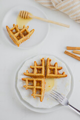 Waffle with honey. Aesthetic composition. Food Styling.