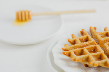 Waffle with honey. Aesthetic composition. Food Styling.