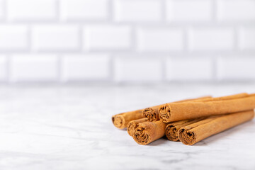 Ceylon cinnamon.Cinnamon sticks on a textured wooden background. Cinnamon roll and powder. Spicy spice for baking, desserts and drinks. Fragrant ground cinnamon. Close-up. Place for text. copy space