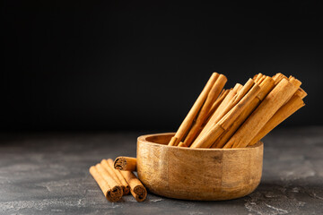 Ceylon cinnamon.Cinnamon sticks on a textured wooden background. Cinnamon roll and powder. Spicy spice for baking, desserts and drinks. Fragrant ground cinnamon. Close-up. Place for text. copy space