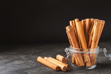 Ceylon cinnamon.Cinnamon sticks on a textured wooden background. Cinnamon roll and powder. Spicy spice for baking, desserts and drinks. Fragrant ground cinnamon. Close-up. Place for text. copy space
