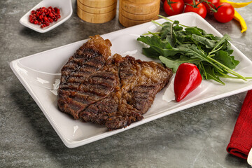 Grilled chuck roll steak with arugula