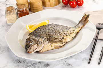 Baked Dorado fish served lemon