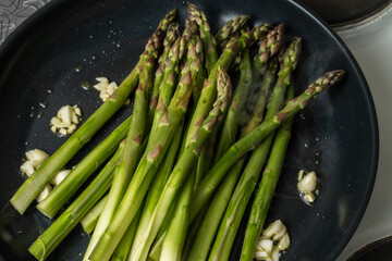 Asparagus fried with garlic in melted butter