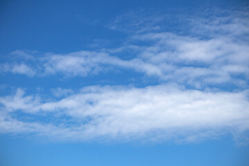 Natural pattern. Cloudy blue sky background. Calm sky and bright clouds in sunlight