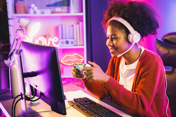 African American girl streamer playing online fighting with Esport skilled team wearing headphones...