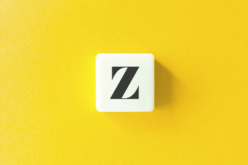 Capital Letter Z. Text on Block Letter Tiles against Yellow Background.