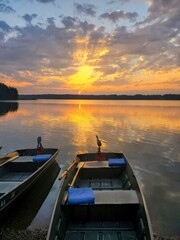 Sunrise over lake with fishing boats