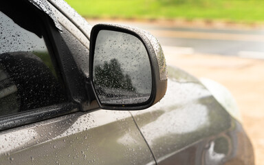 Car in parking with
water drop rainy, foggy autumn day. Focus on car mirror.
Concept of safety driving problem.