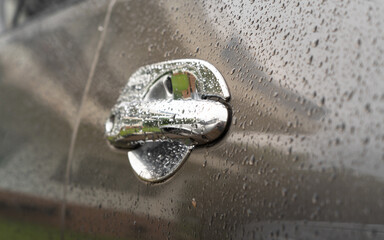 Car in parking with water drop rainy, foggy autumn day. Focus on car handle. Concept of safety driving problem.