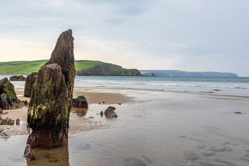 Rock formations on the beach, at Bigbury-on-sea on the Devon coast - Powered by Adobe