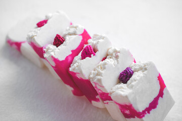 Handmade natural eco-friendly raspberry berry soap with raspberry scent on white background.