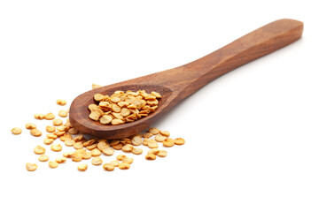 Front view of a wooden spoon filled with Organic Capsicum or Bell Pepper (capsicum annuum) seeds. Isolated on a white background.