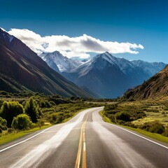 Fototapeta premium Scenic view of an empty asphalt road through a mountain valley