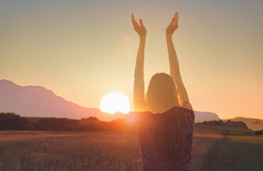 Joyful Person Raising Arms morning in Rural Field Under Summer Sunlight