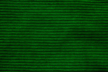 Closeup of green corduroy cloth as patterned textured background