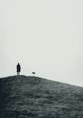 Man and bird on hilltop overlooking ocean