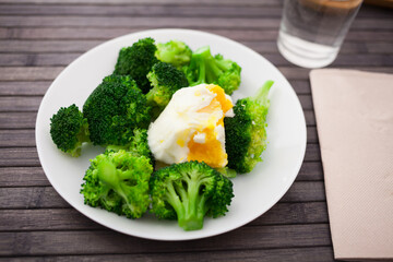 Healthy food. steamed broccoli inflorescences with boiled egg in a bowl - 803356570