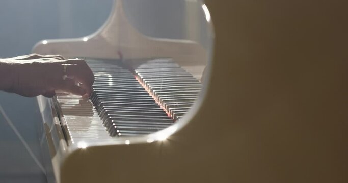 Musician plays on a grand piano. The pianist hands playing classical music on a piano