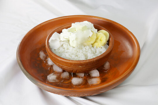 Doi Chira on clay bowl, traditional Bangale healthy and cool summer food . Main ingredient are water soaked flatten rice and curd. Others are Sugar, Salt, Banana slices, Coconut etc.