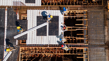 Men from the construction industry, working on the work of a building under construction. Placing...