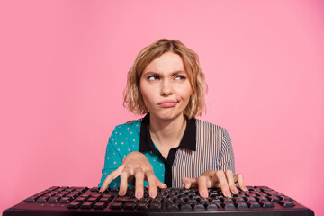 Photo of pretty girl unsure web camera typing keyboard look empty space wear trendy striped cyan...