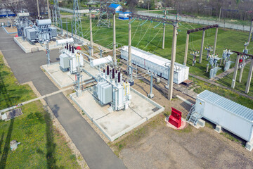 Aerial view of electrical towers and large electrical substation in spring