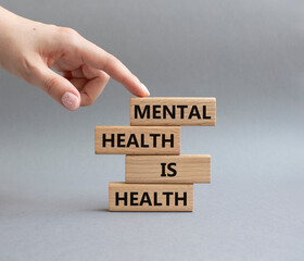 Mental Health symbol. Wooden blocks with words Mental Health is Health. Beautiful grey background....