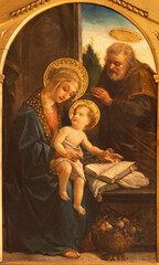 MILAN, ITALY - MARCH 6, 2024: The Painting of Holy Family in the church Basilica di Santa Eufemia by Luigi Morgari inspired by renaissance painters (1896).