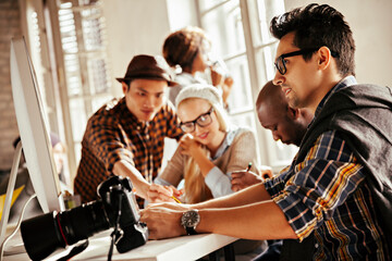 Diverse creative team working on photography project in studio