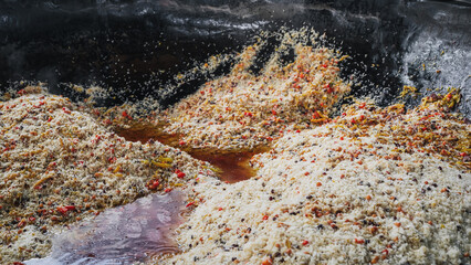 traditional oriental dish of Uzbek cuisine is rice pilaf with vegetables and spices in cauldron in...