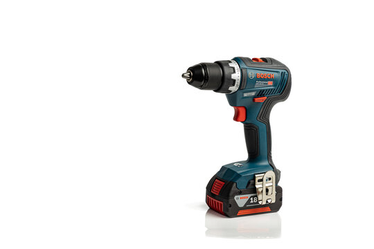 Lyon, France - February 6, 2024: Side view of Bosch cordless drill driver power tool with 18V battery pack, isolated on a white background with copy space;.
