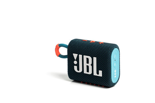 Lyon, France - February 6, 2024: JBL Go 3 Bluetooth speaker isolated on a white background, with orange and light blue accents; Bluetooth speaker on white background with copy space