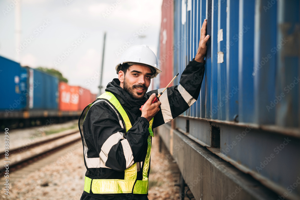 Wall mural supervisor inspecting inventory or task information on freight train cars and shipping containers. t