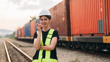 Supervisor inspecting inventory or task information on freight train cars and shipping containers....