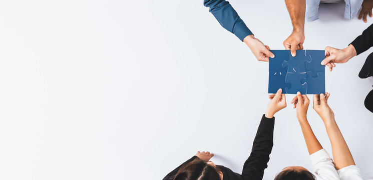 Top view panorama banner of business team joining jigsaw puzzle together over meeting table symbolize business partnership and collective unity teamwork in problem solving solution. Prudent
