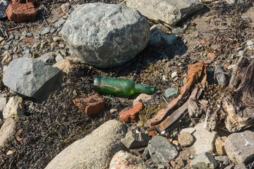 old bottle and rusty iron as well as other debris from the sea coast at low tide
